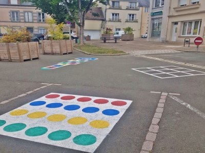 Les enfants de l'accueil de loisirs Lilas Plage ont créé trois jeux peints au sol (marelle, scorpion, twister) sur la place Neuve, offrant un espace ludique et sécurisé pour l'été. - Naomie Jourand